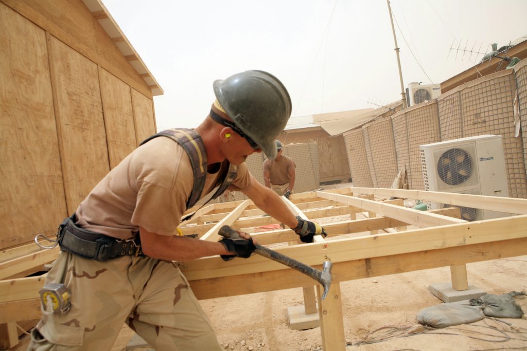 080606-N-9623R-162 IRAQ (June 6, 2008) Builder 2nd Class Jeffery Bivens, assigned to the ÒTiger TeamÓ of Naval Mobile Construction Battalion (NMCB) 17 hammers in sections of a sub-floor addition for a Marine Corps SYSCOM building. The Tiger Team is comprised of highly skilled Seabees with tools and materials who perform quality of life, safety and force protection upgrades to remote Marine outposts. U.S. Navy photo by Mass Communication Specialist 2nd Class Kenneth W. Robinson (Released)